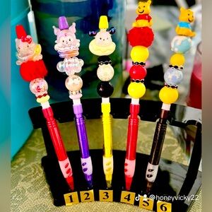 hello Kitty and friend and Winnie the Pooh pencil.